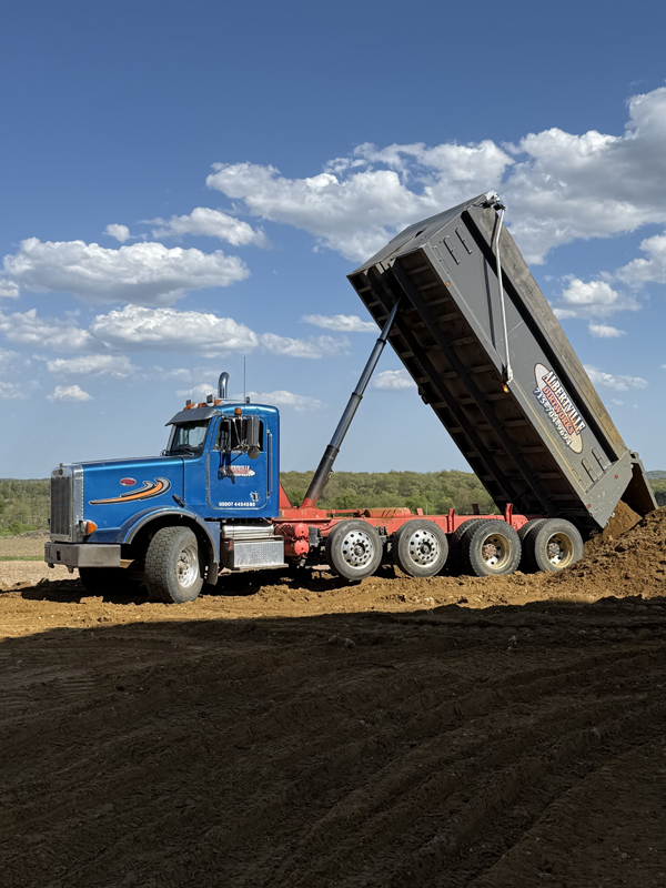 Hauling and dumping topsoil Hauling and dumping topsoil