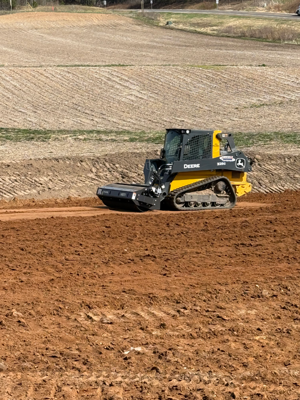 Rolling freshly sloped topsoil Rolling freshly sloped topsoil